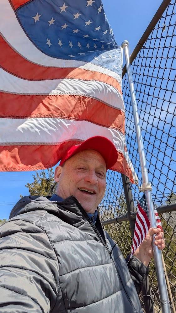 William Falcetano with an American flag